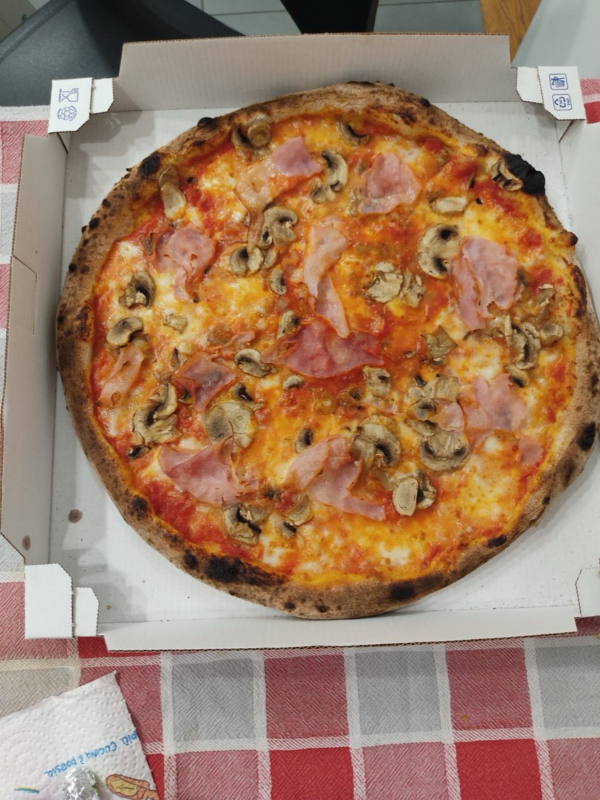 Pizza tonda con prosciutto cotto e funghi nel cartone da asporto